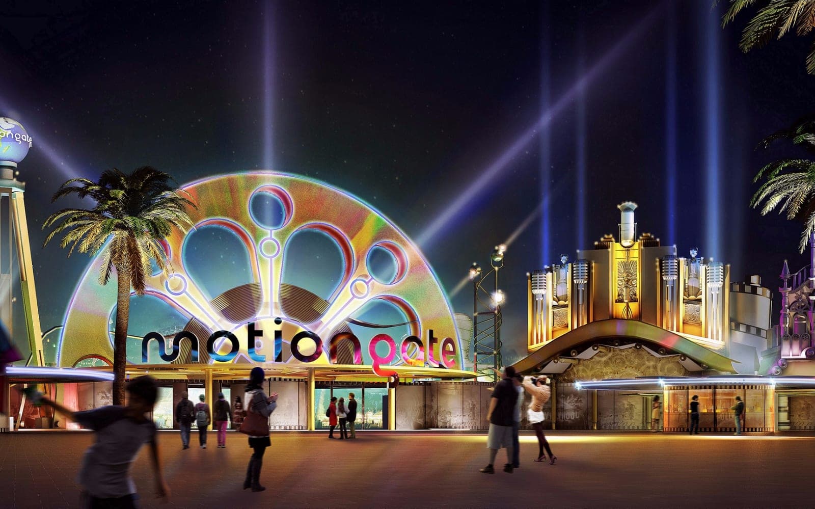 The lit Motiongate Dubai entrance arch at night with searchlights overhead