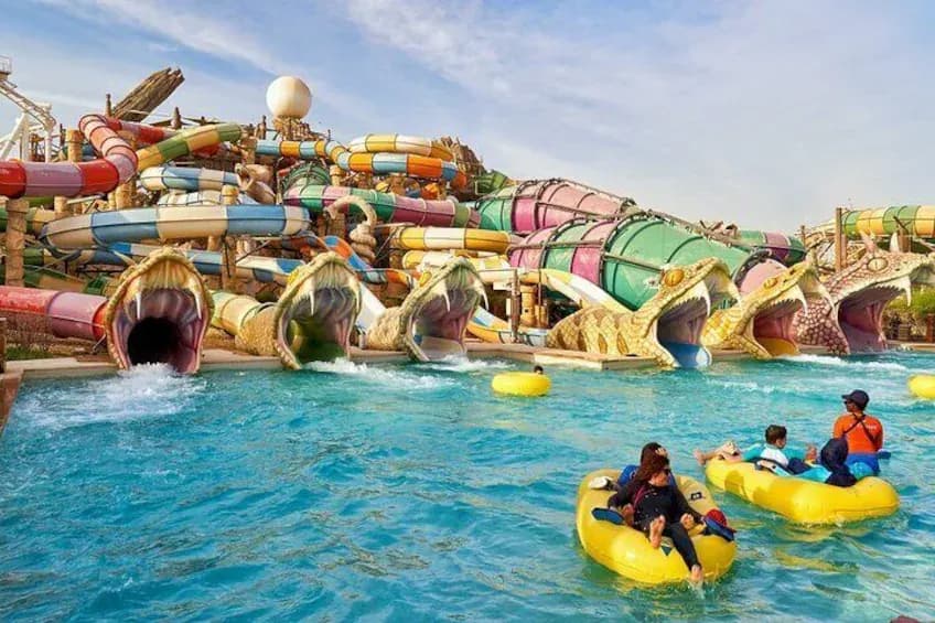 Coloured slides and a rider on a yellow ring at Yas Waterworld Abu Dhabi