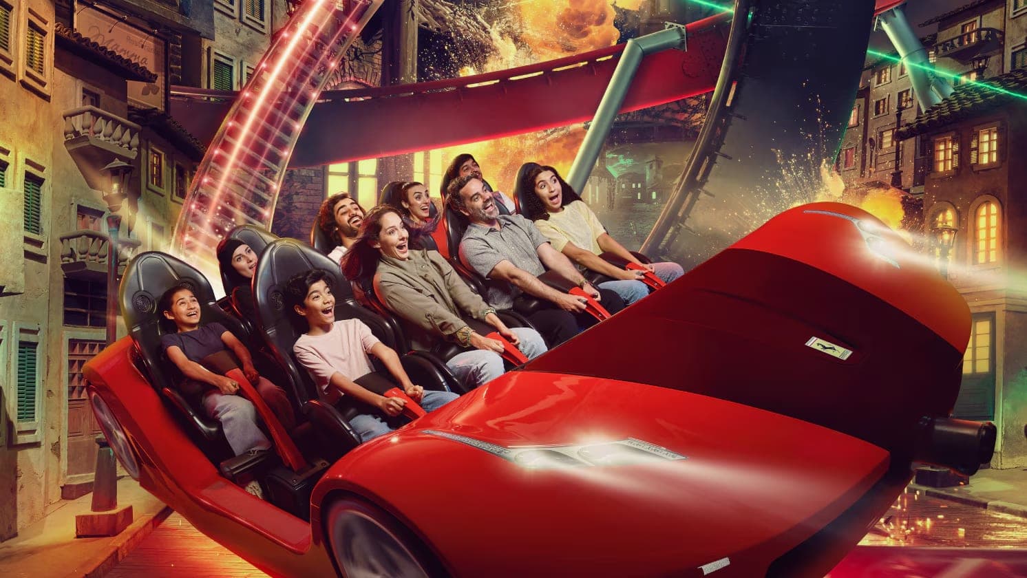 Riders in a red Ferrari shaped car on an indoor ride at Ferrari World Abu Dhabi