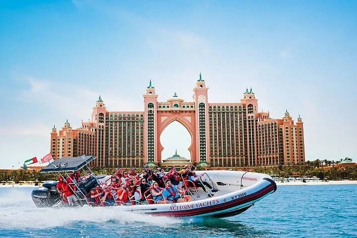 A speedboat full of passengers passing Atlantis The Palm