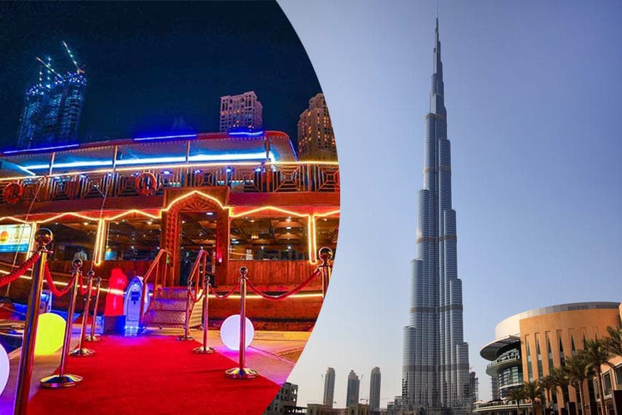 A lit dhow at the quayside beside the Burj Khalifa at night